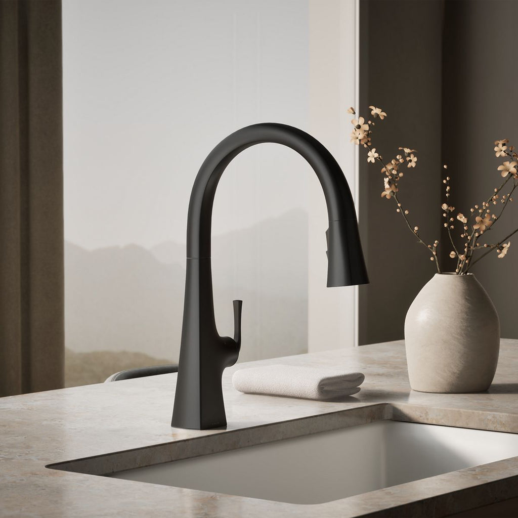 Graze Touchless pull-down kitchen sink faucet with three-function sprayhead, close-up in a room setting, K-22068-BL