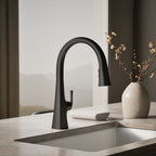 Graze Touchless pull-down kitchen sink faucet with three-function sprayhead, close-up in a room setting, K-22068-BL