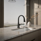Graze Touchless pull-down kitchen sink faucet with three-function sprayhead, in use in a room setting, K-22068-BL