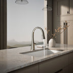 Graze Touchless pull-down kitchen sink faucet with KOHLER Konnect and three-function sprayhead, in use in a room setting, K-22068-WB-SN