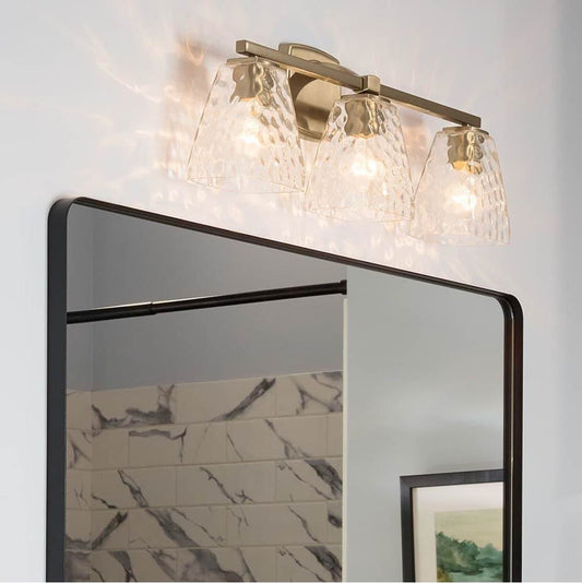 KICHLER 55216CPZWTR Marant 23.75" 3-Light Vanity Light with Clear Water Glass in Champagne Bronze