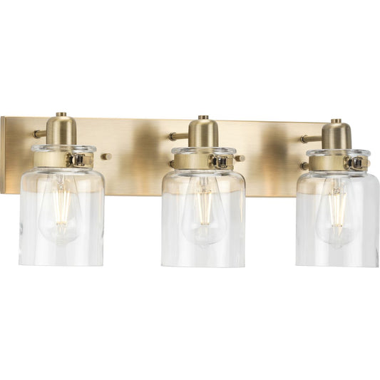 PROGRESS LIGHTING P300047-163 Vintage Brass Calhoun Collection Three-Light Vintage Brass Clear Glass Farmhouse Bath Vanity Light