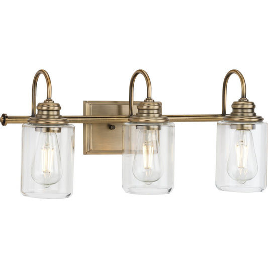 PROGRESS LIGHTING P300322-163 Vintage Brass Aiken Collection Three-Light Clear Glass Vintage Style Brass Farmhouse Style Bath Vanity Wall Light