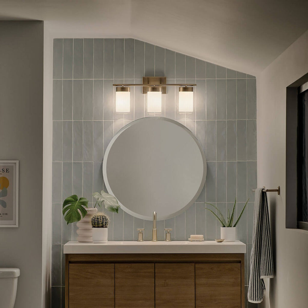 KICHLER 55112BNB Ciona 24" 3 Light Vanity Lighte With Round Ribbed Glass Brushed Natural Brass