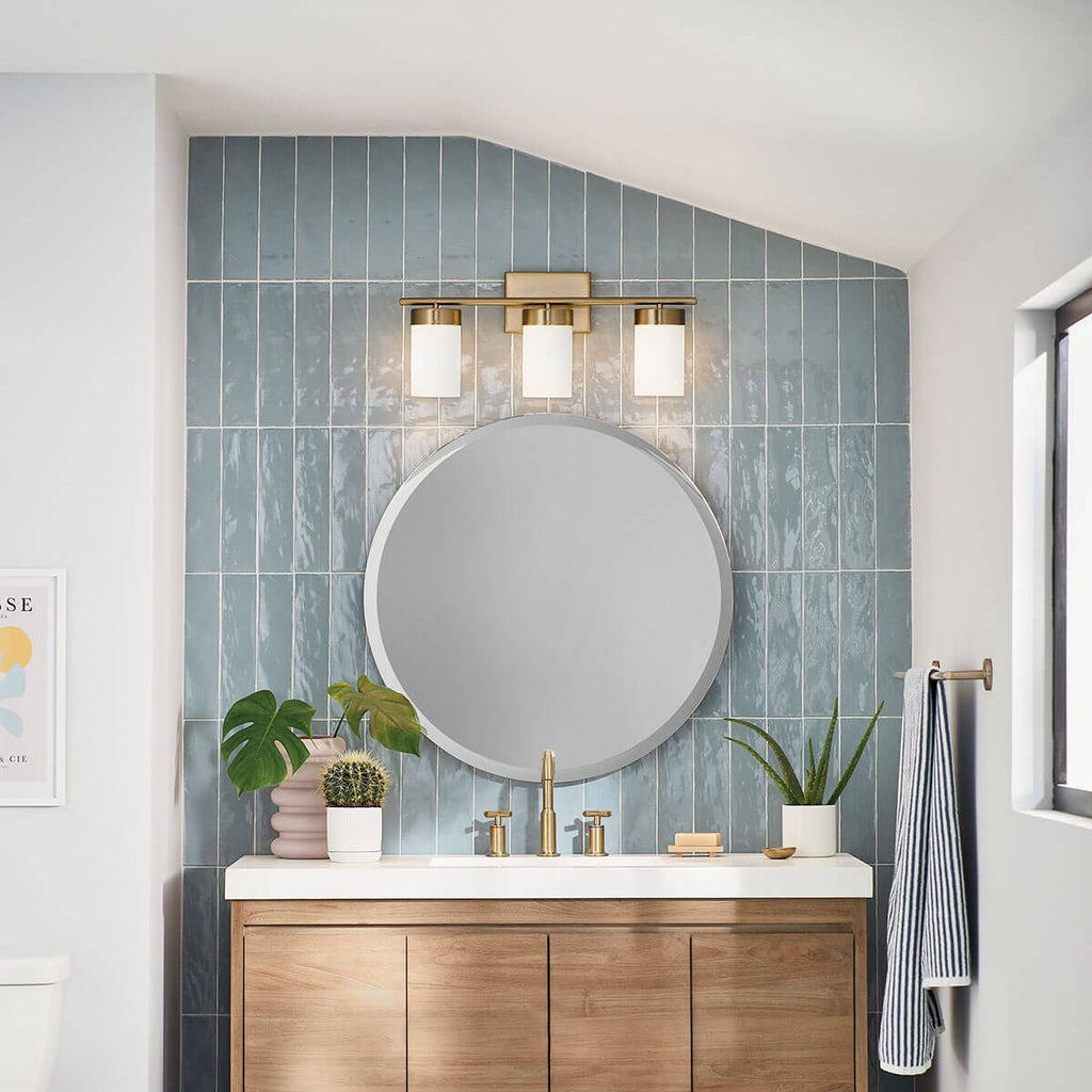 KICHLER 55112BNB Ciona 24" 3 Light Vanity Lighte With Round Ribbed Glass Brushed Natural Brass