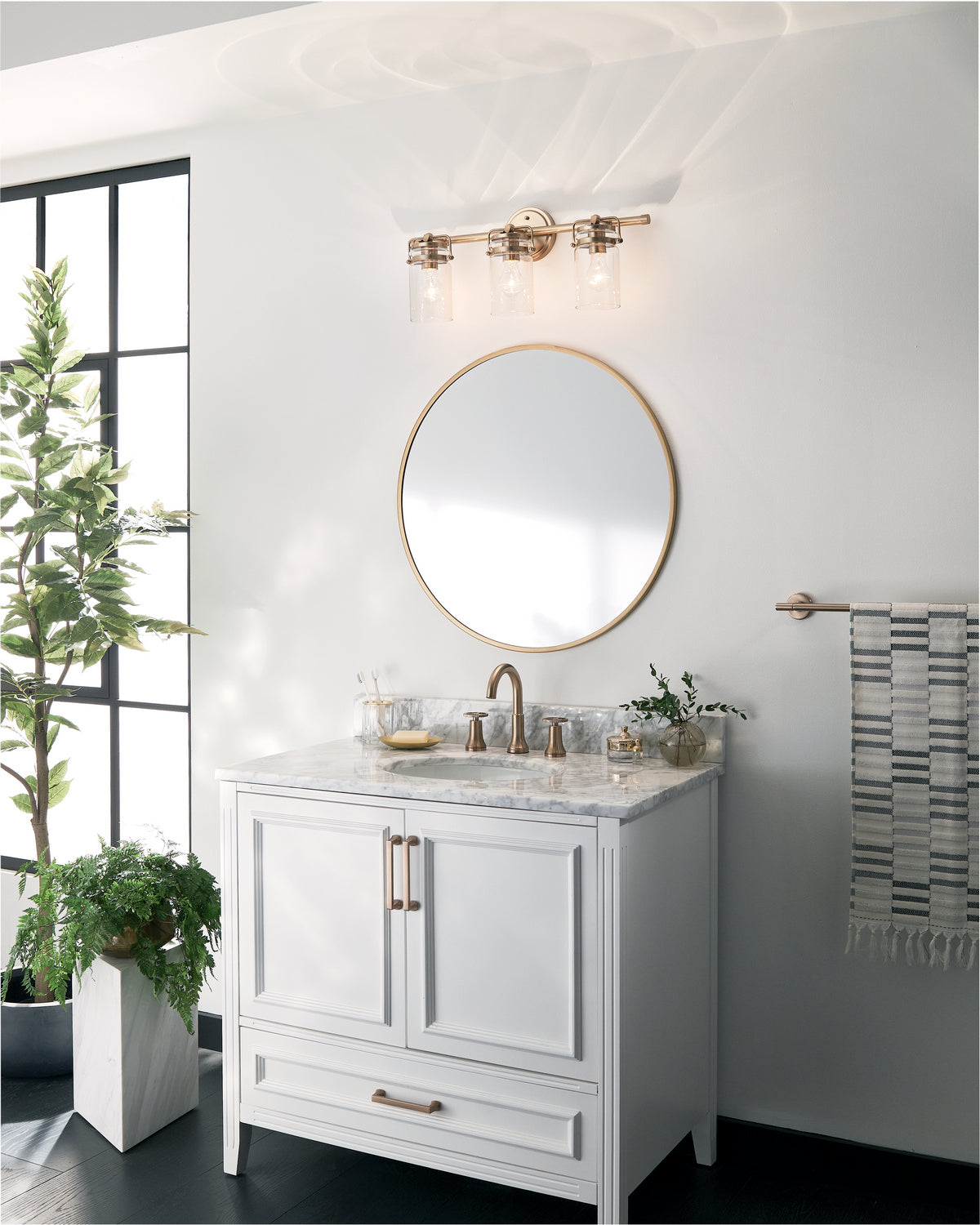 KICHLER 45689CPZ Brinley 24" 3 Light Vanity Light With Clear Glass In Champagne Bronze