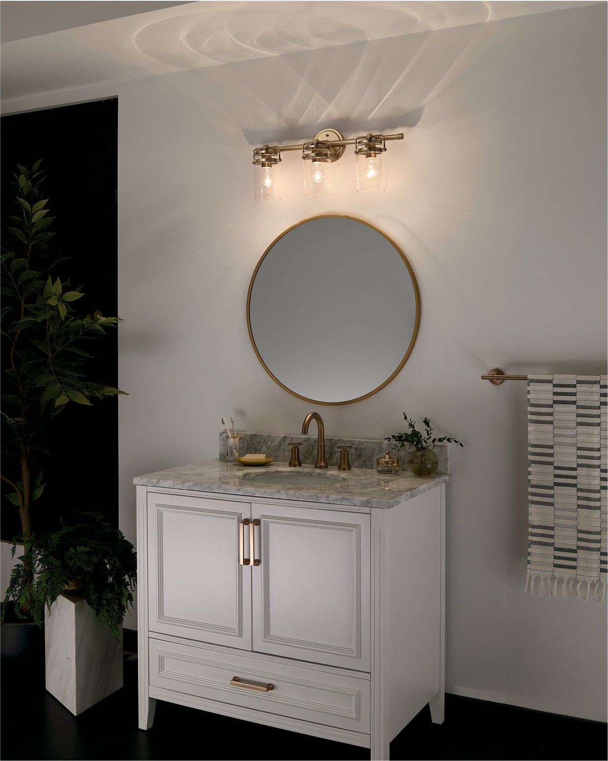 KICHLER 45689CPZ Brinley 24" 3 Light Vanity Light With Clear Glass In Champagne Bronze